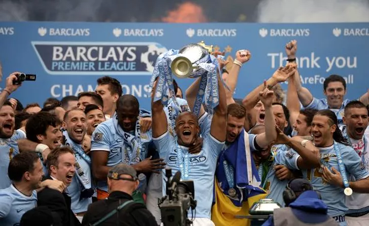 Manchester City's captain Vincent Kompany celebrates after winning the English Premier League trophy following their soccer match against West Ham United