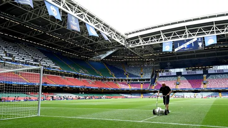 A groundsman puts the finishing touches to the pitch ahead of the UEFA Champions League final football match between Juventus and Real Madrid at The Principality Stadium in Cardiff, south Wales, on June 3, 2017. / AFP PHOTO / Glyn KIRK        (Photo credit should read GLYN KIRK/AFP/Getty Images)