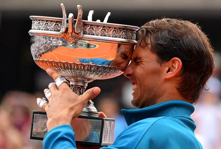 Rafael Nadal of Spain bites the championship trophy after winning his French Open men's final match against Dominic Thiem of Austria at Roland Garros in Paris on June 10, 2018. Nadal defeated Thiem 6-4, 6-3, 6-2 to win his 11th French Open championship. Photo by Christian Liewig/ABACAPRESS.COM